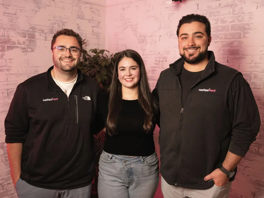 Three members of the RestauRent team smiling together