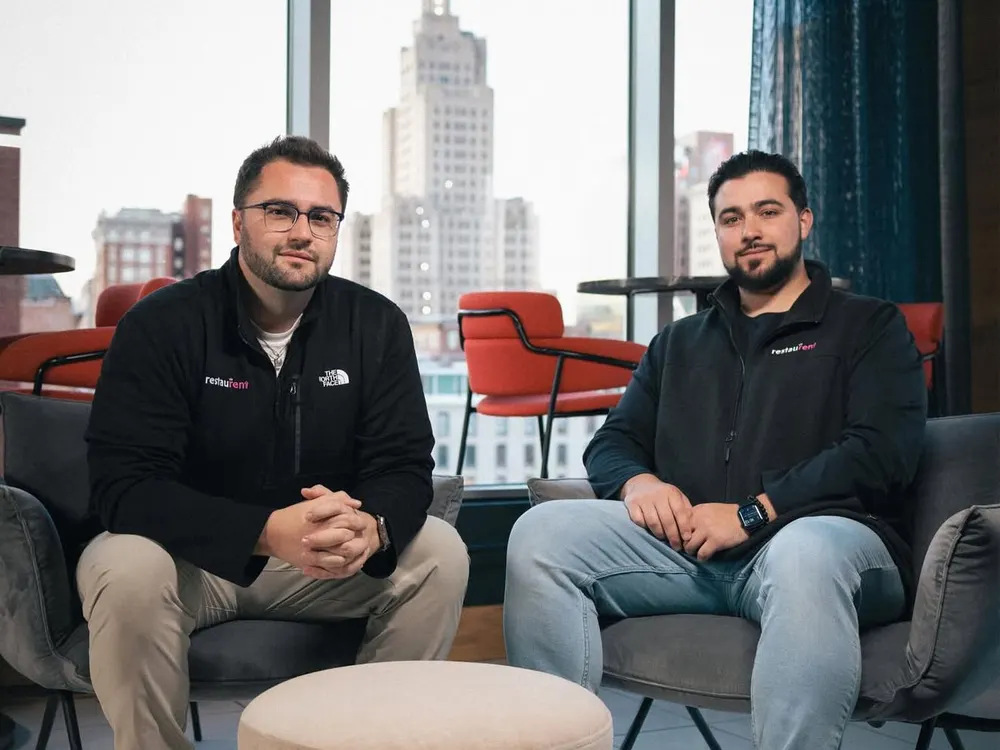 RestauRent co-founders seated in a modern lounge