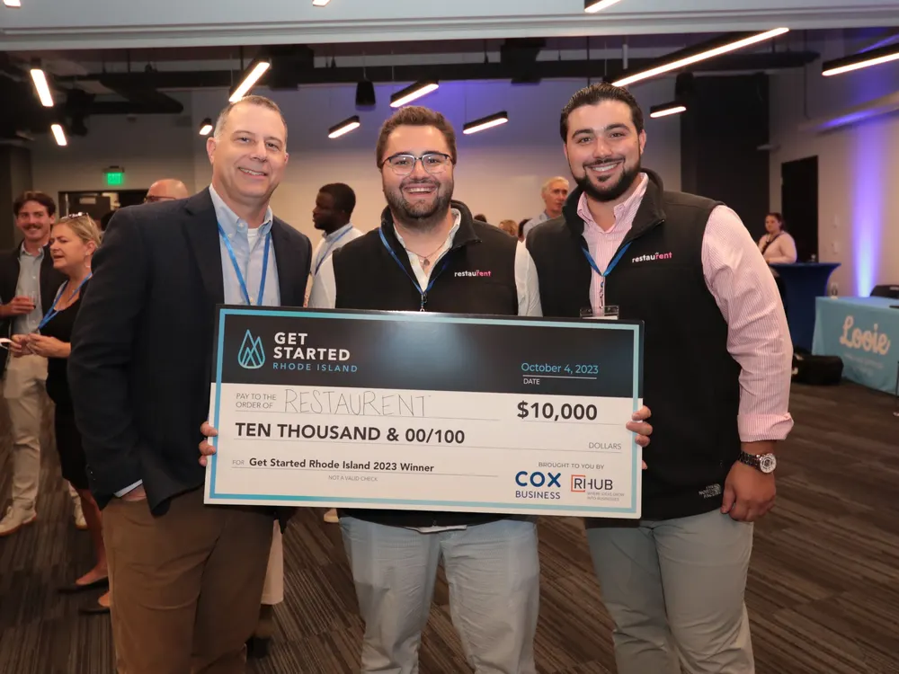 RestauRent team accepting a pitch competition check