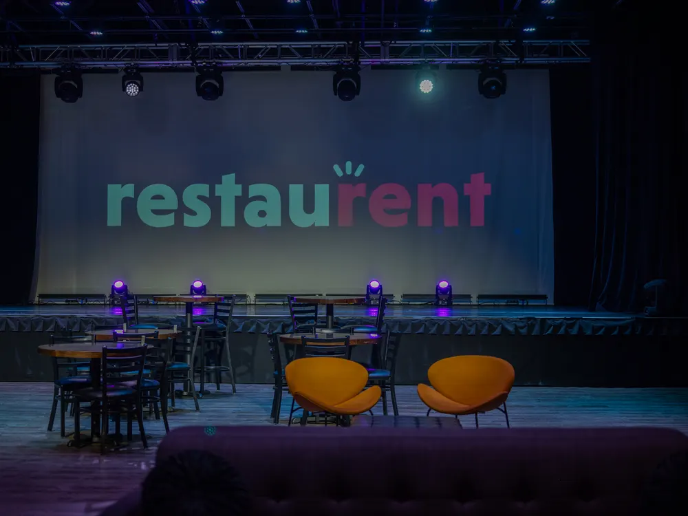 RestauRent branding on screen at an event venue